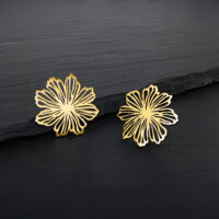 Zwei goldene Blumen Ohrstecker auf dunklem Hintergrund