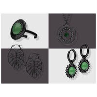 Schwarze Schmuckstücke auf grauem Hintergrund, inkl. grüner Akzente