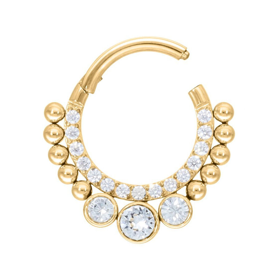 Kultainen septum clicker kristalleilla, avoimessa tilassa valkoisella taustalla