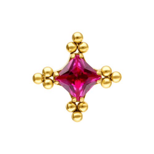 Kultainen lisäosa, jossa punainen kristalli keskellä ja pienet kultaiset pallot reunoilla, valkoisella taustalla